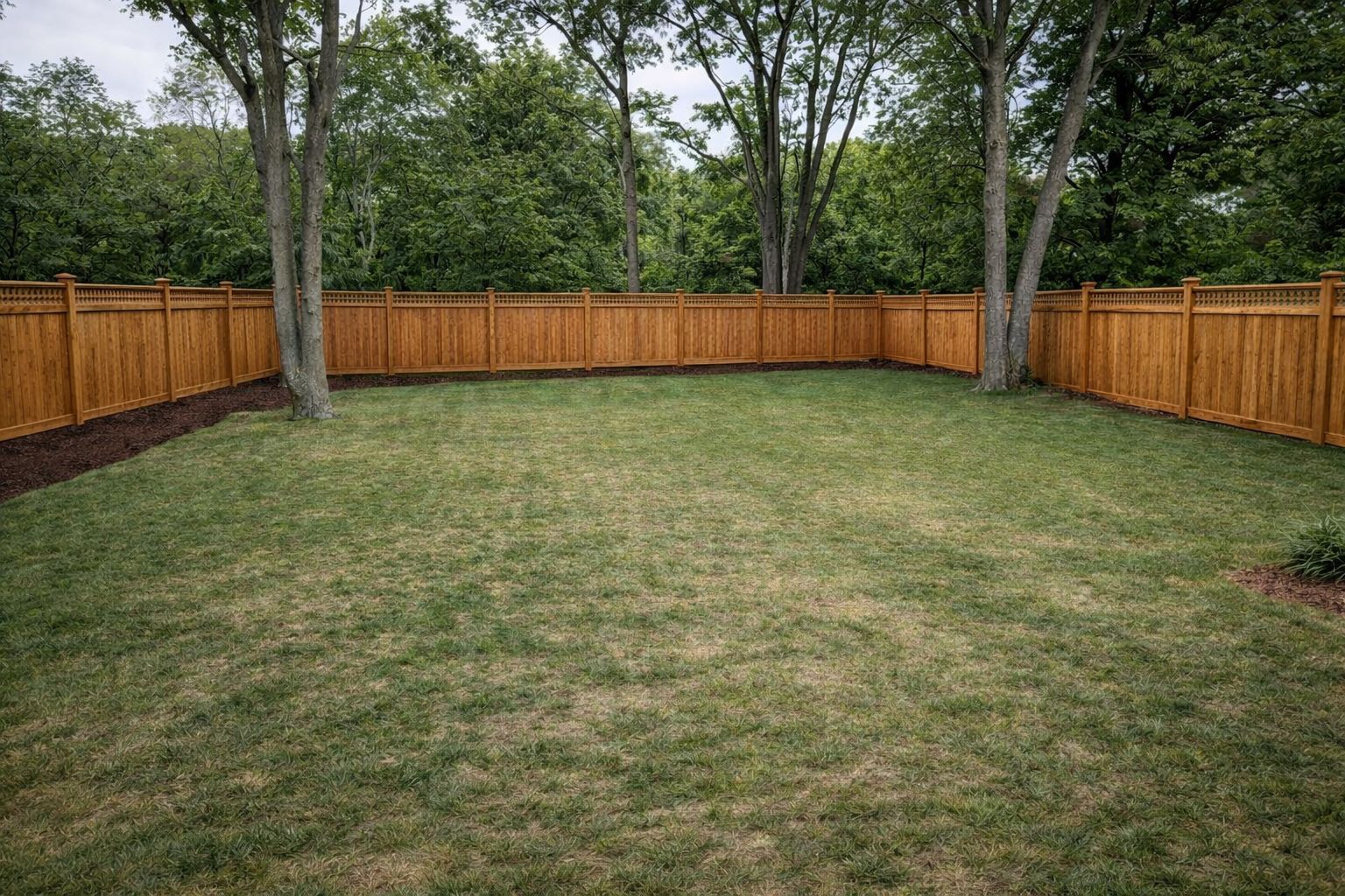 Privacy fence with cedar boards and decorative top