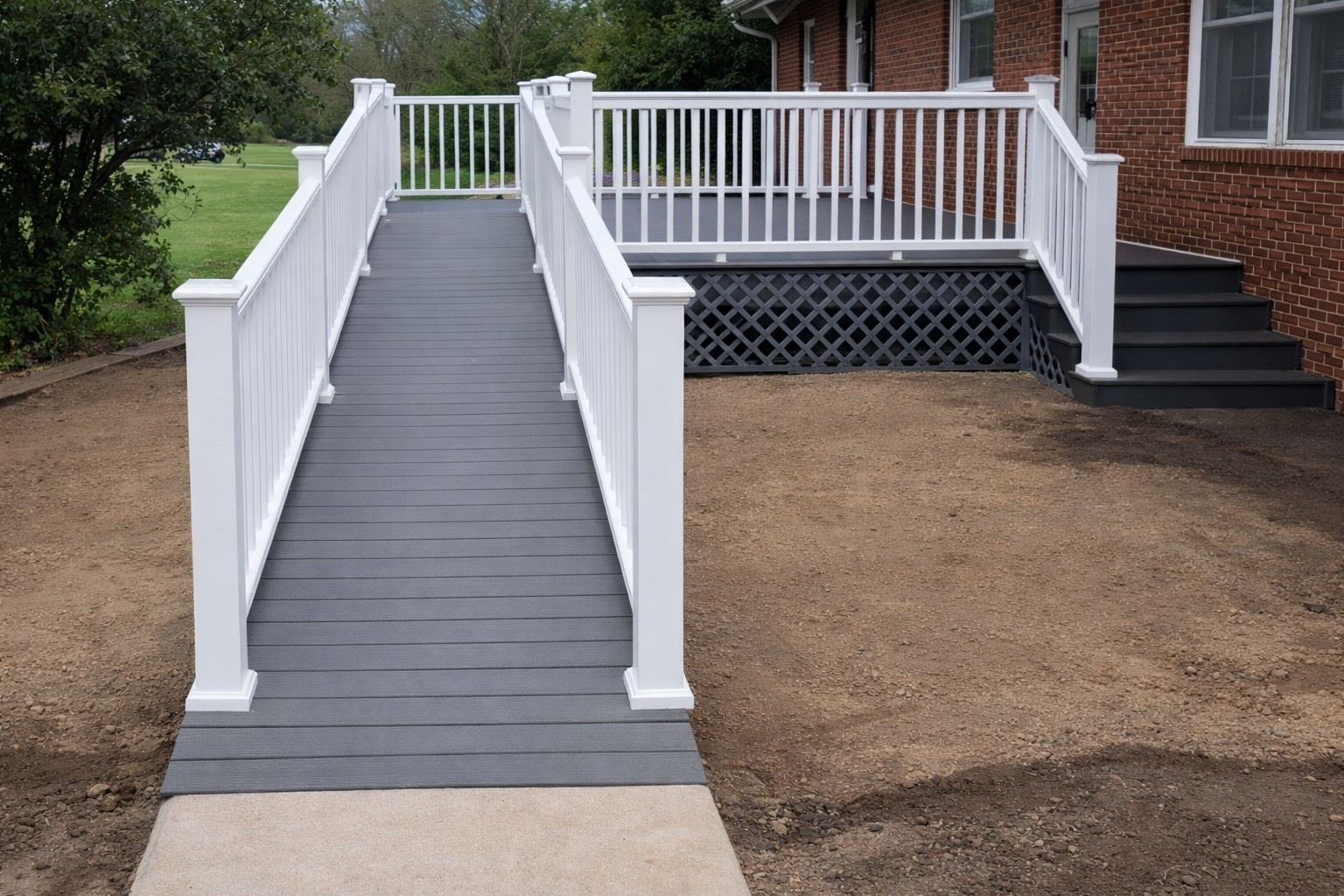Low maintenance composite ramp with aluminum railings
